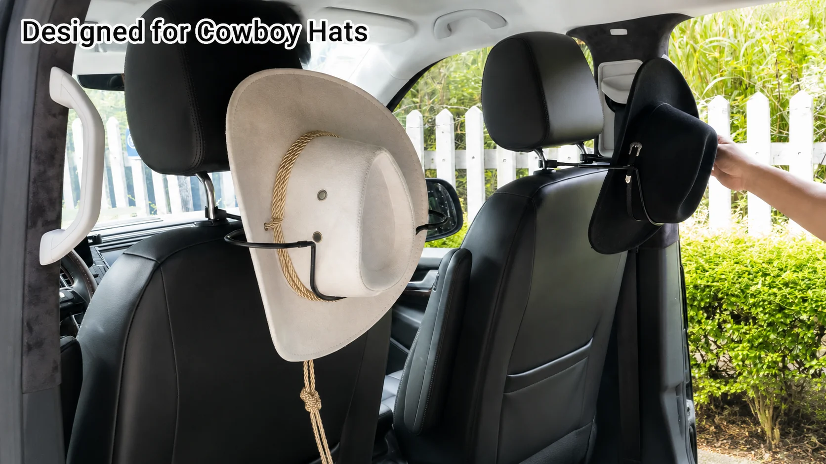 Car seatback cowboy hat rack holder keeping a cream western hat and black fedora securely stored in place.